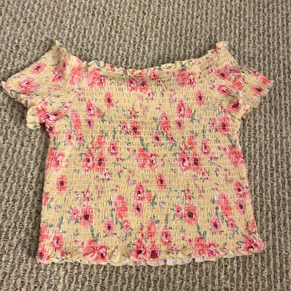pink kid’s off-shoulder shirt